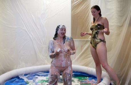 Amateur lesbians drench themselves in gunk during swimming parties.