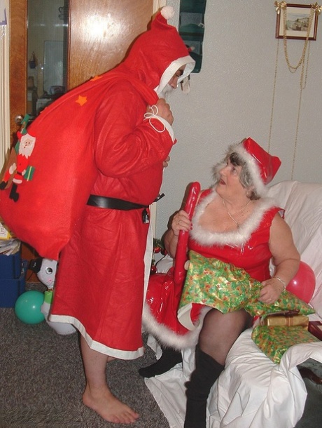 On a covered couch, Santa plays with Obese Nana and Grandma Libby can be heard toting him while she performs handcuffs.