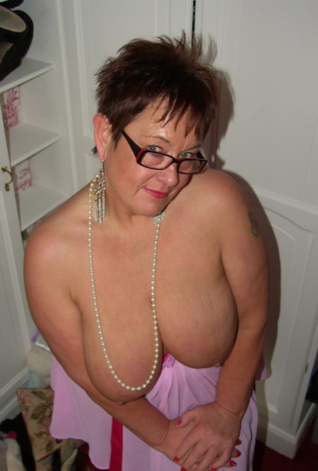 Amateur BBW Warmsweethoney looses her large tits from lingerie with glasses on