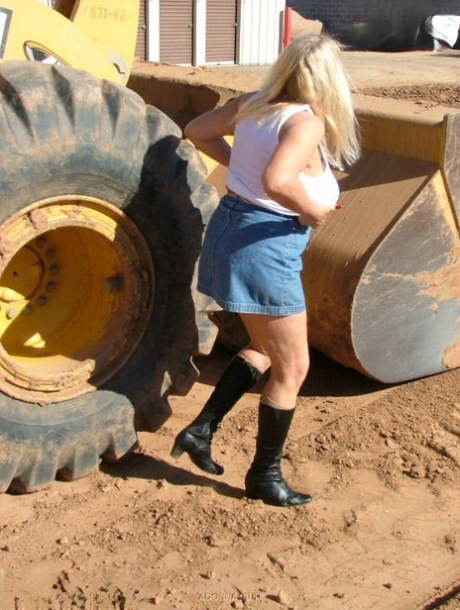 Heavy equipment accompanies Adonna, an overweight and well-built blonde woman, as she exposes herself.