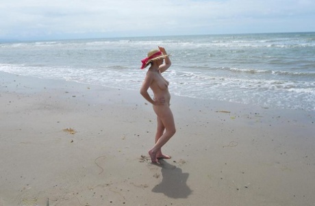 The sun hat is all that Barby Slut wears as he braves the ocean in an older amateur outfit.