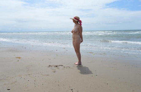 The older Barby Slut ventures into the ocean wearing only a sun bonnet.