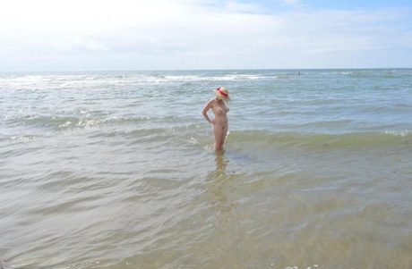 Armed with only a sun bonnet, Barby Slut, an older member of the amateur cast, ventures into the ocean to swim.