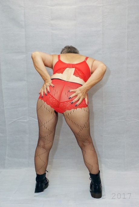 In her Savana, an elderly and amateur, she dresses in red pantyhose and black boots.