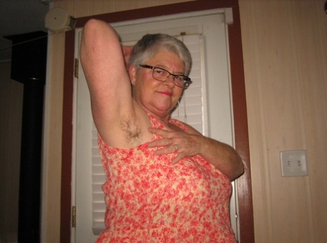 Before her curly tits, the Fat Nan Girdle Goddess displays her beard by wincing through her armpits.