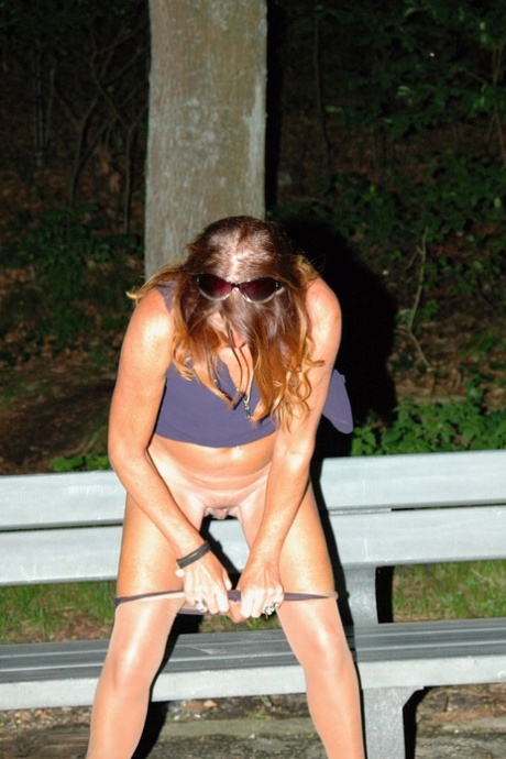 An amateur female searches for a pussy on the park bench at night by turning off her water hose.