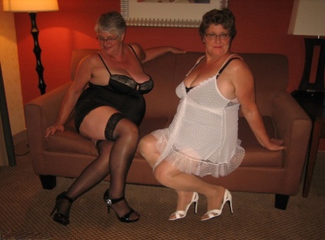 Big Bumps: The fat girdle goddess and her lesbian lover show off their saggy breasts.