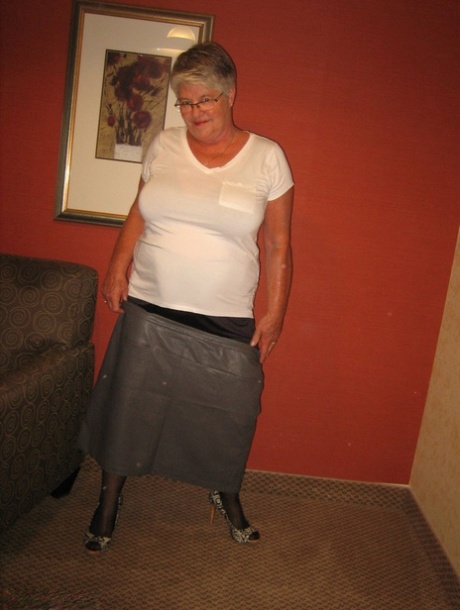 The Girdle Goddess, an elderly woman, removes her chubby body from clothing in stockings.