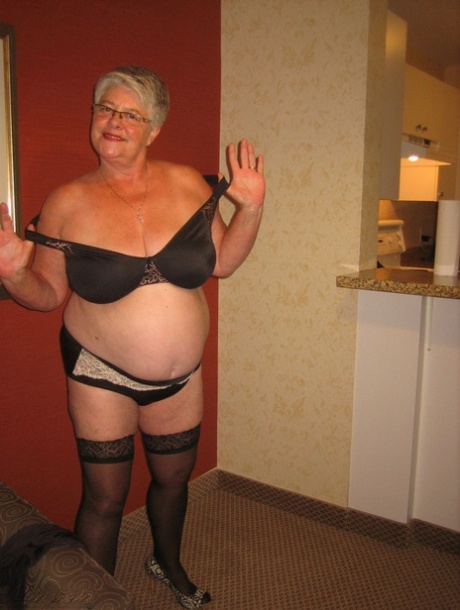 In stockings, the Girdle Goddess, an elderly woman's chubby figure, releases herself from her clothing.