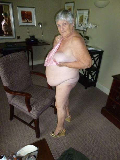 Obese Grandmother Licks Her Own Nipples As She Strips Naked In Living Room