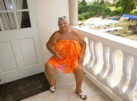 Fat Mama, Grandma Libby, exposes her tan-rimmed body on the balcony.