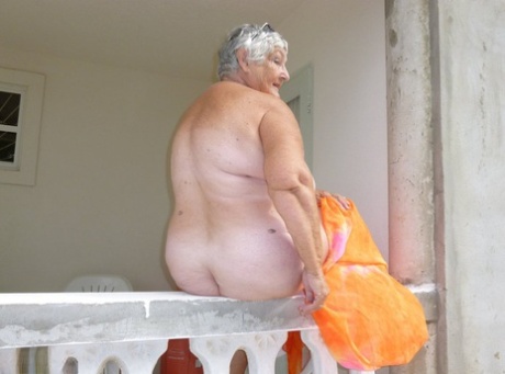 Despite her weight, Grandma Liberty exposes herself on the balcony covered in tanning.