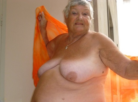 Big sister Grandma Libby flaunts her dark skinned body on a balcony.
