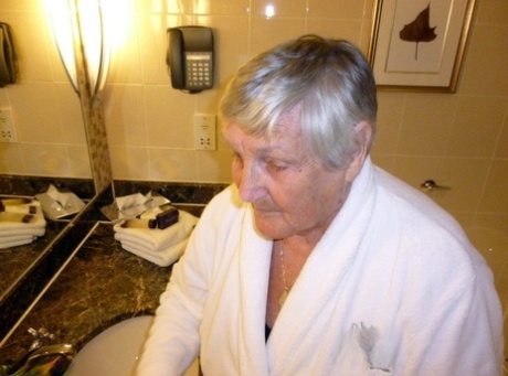 In a cupless bra pose, Grandma Libby removes her bathrobe and is shown naked.