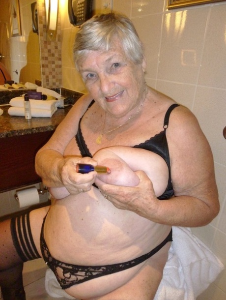 A cupless bra and nude pose are achieved by Grandma Libby, who removes a bathrobe for the most part.
