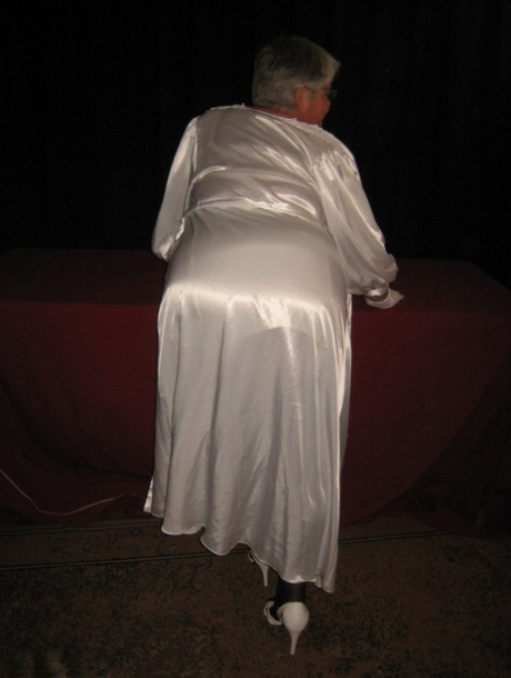 With silver hair, the Oma Girdle Goddess flaunts her girdle panties with her enormous saggy tits.