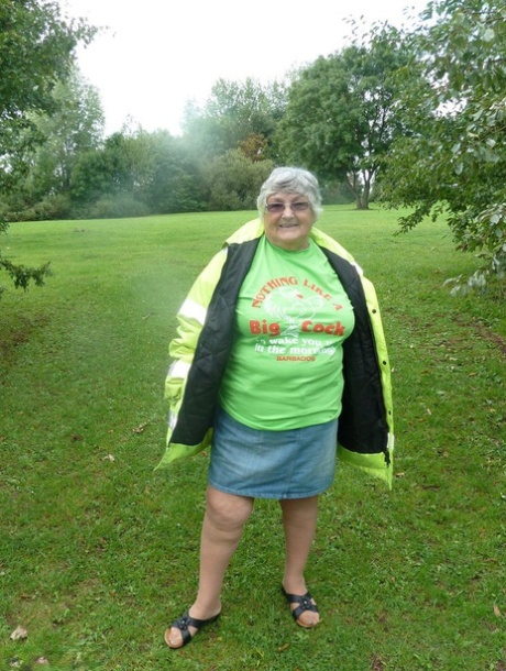 Grandma Libby, a fat British woman, exposes herself by a tree in a park.