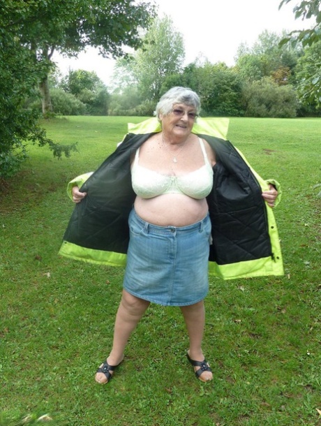 Fat woman: British beauty Grandma Libby bares herself by the side of a tree in a park.