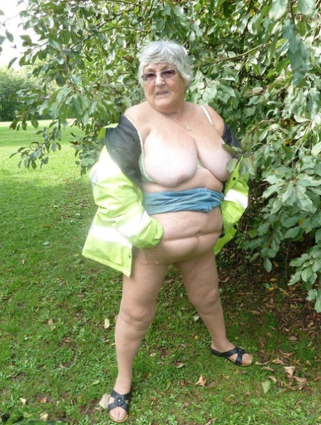 A tree in a park is approached by Grandma Libby, an overweight British woman, who exposes herself to it.