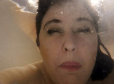 Half-naked arrest: British amateur Juicey Janey is pictured naked in front of a full bathtub.