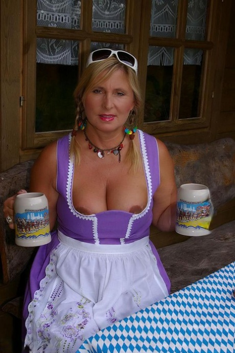 Thick Blonde Serves Beer With Big Boobs Out After Putting In Wood In The Nude