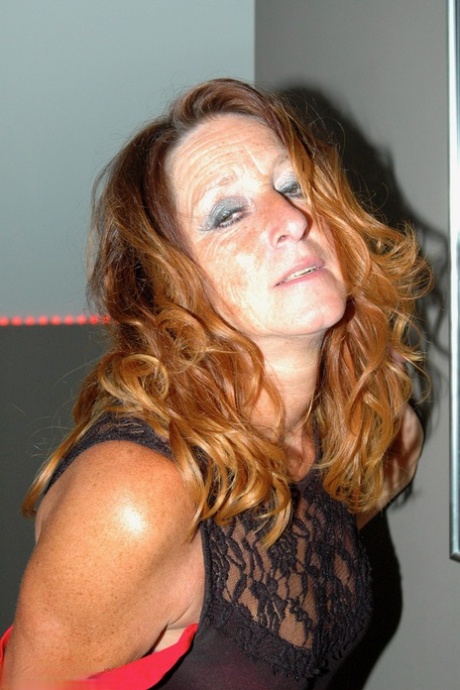 An unrefined housewife in flared jeans and nylon stockings makes a fashion statement.