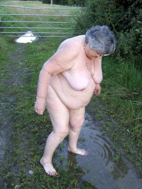 Big sister, Grandma Libby (of 10 plus years) dips into a pool of water before covering herself in mud.