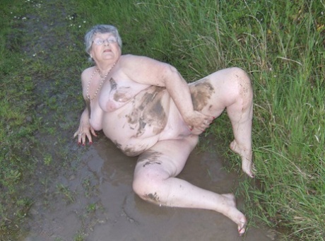 Fat aunt Grandma Libby dips into a puddle before stuffing herself into mud.