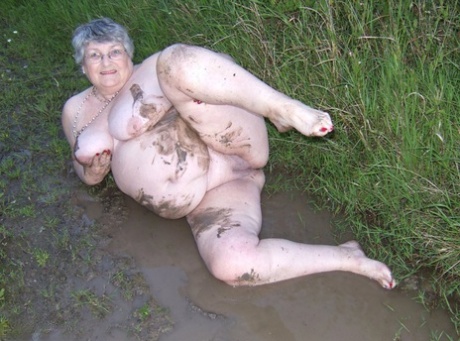Old Aunt Libby, who is fat and obese, enters a wet area before sinking into the mud.