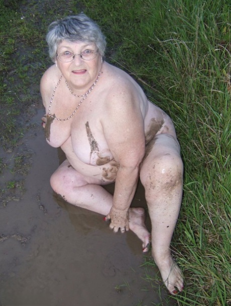 Fat mother-to-be Libby plunges into a pool of water and dips herself in the mud.