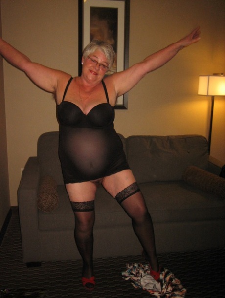 A Girdle Goddess who is an old man without any professional experience wears a large breast as she dresses in hosiery.