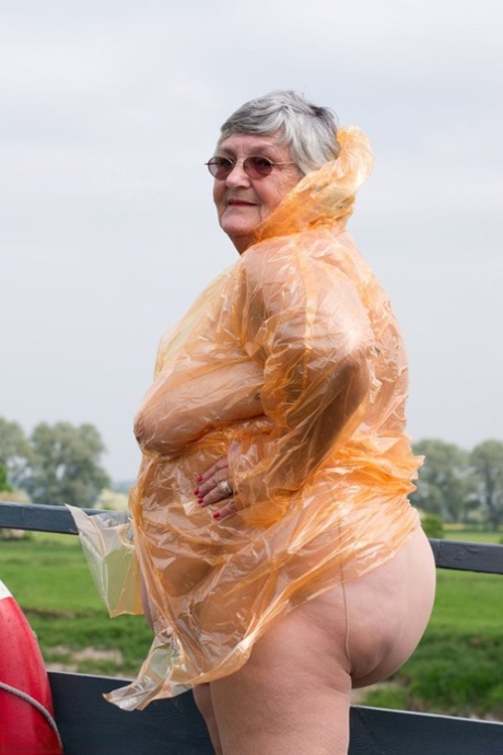 Obese oma Grandma Libby doffs a see-through raincoat to get naked on a bridge #4