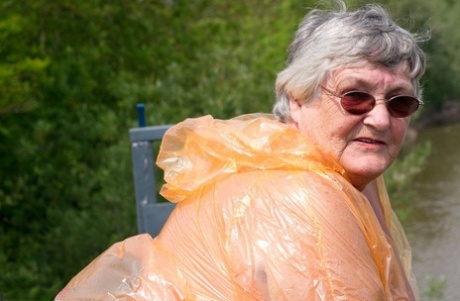 Obese oma Grandma Libby doffs a see-through raincoat to get naked on a bridge Amateur xxx porn video pic #13