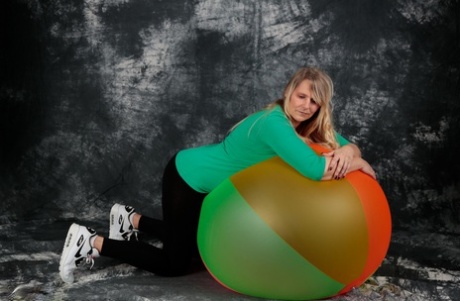 Sweet Susi, a blonde novice, is fully exposed on a bouncy ball.