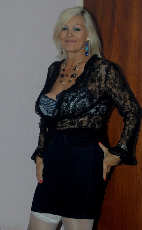 The older, platinum-blonde Platinum Blonde undressing to pose in her seductive lace lingerie.