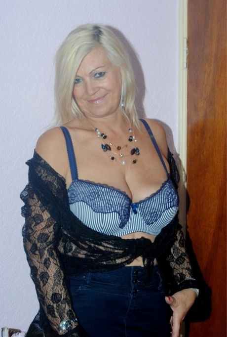 Older woman Platinum Blonde undressing to wear her seductive lace lingerie.