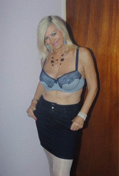 Platinum Blonde, who is older than she is, undressing to be seen in her seductive lace lingerie.