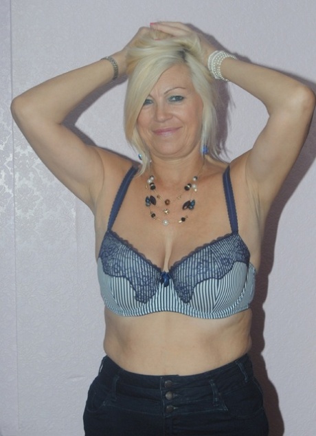 The older Platinum Blonde in her adult body undressing to pose for pictures wearing a suggestive pair of lace pants.