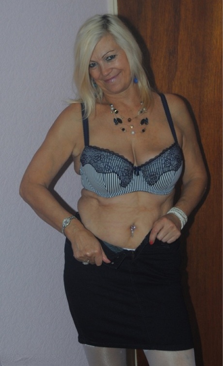 Older mature Platinum Blonde undressing to pose in her sexy lace lingerie
