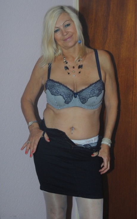 Older mature Platinum Blonde undressing to pose in her sexy lace lingerie