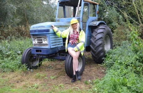 At a job site, Barby Slut exposes herself on heavy equipment while being an adult.