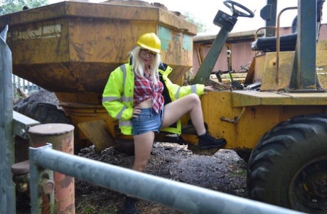 Aged pro, Barby Slut bares herself on heavy equipment at a job site.