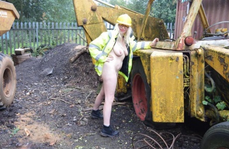 During an outdoor activity at a job site, Barby Slut, who is still quite young, exposes herself on heavy equipment.