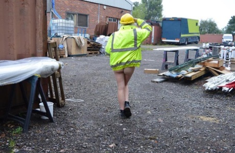 At a job site, Barby Slut takes off her clothes on heavy equipment while being an adult performer.