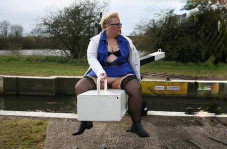 British amusement enthusiast Lexie Cummings, who is overweight at the time, displays her bellies and twitch near a lock.