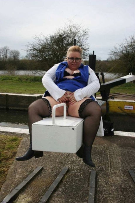 In the UK, overweight Lexie Cummings flaunts her bellies and twist near an isolated location.