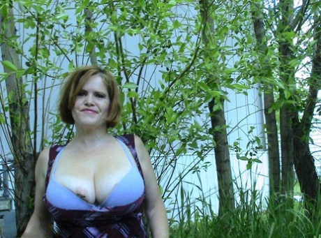 In a cluster of densely forested areas, Misha MILF, an elderly and robust woman, takes in the air.