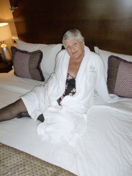 Old Woman Grandma Libby Displays Her Fat Figure On A Bed In Sheer Stockings