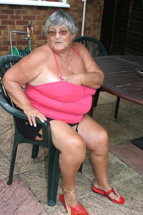 Grandma Libby, the fat cat, performs a nipple lick before embracing her ample buttocks on a patio.