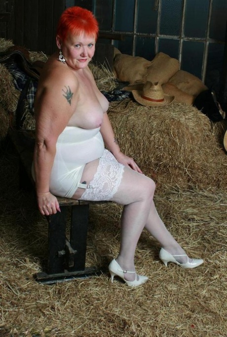 The older redhead Valgasmic Exposed exhibits her tits and twat while in the barn.